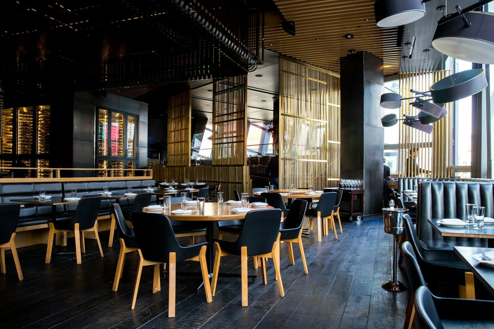 Warm interior of a local restaurant with wooden tables and navy chairs