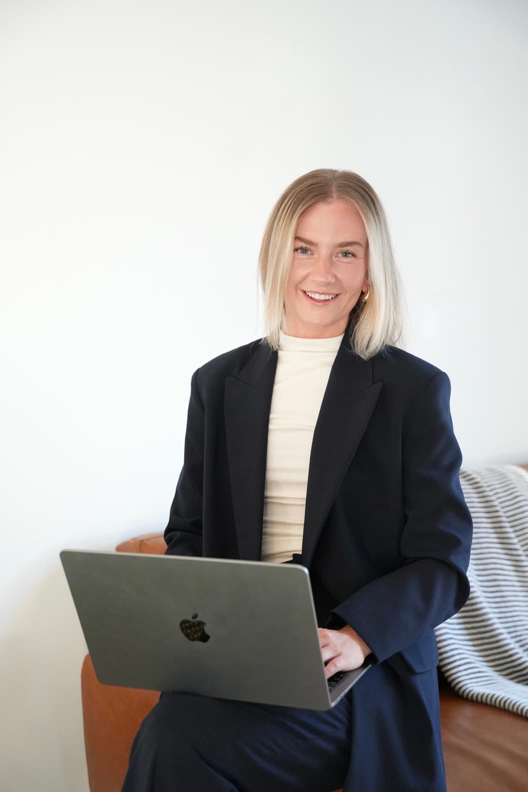 Alexia Burke, Seekly's CEO, working on a laptop